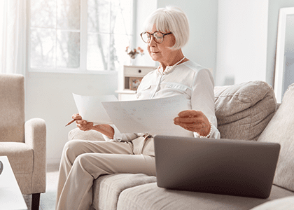 Woman reviewing papers on her couch